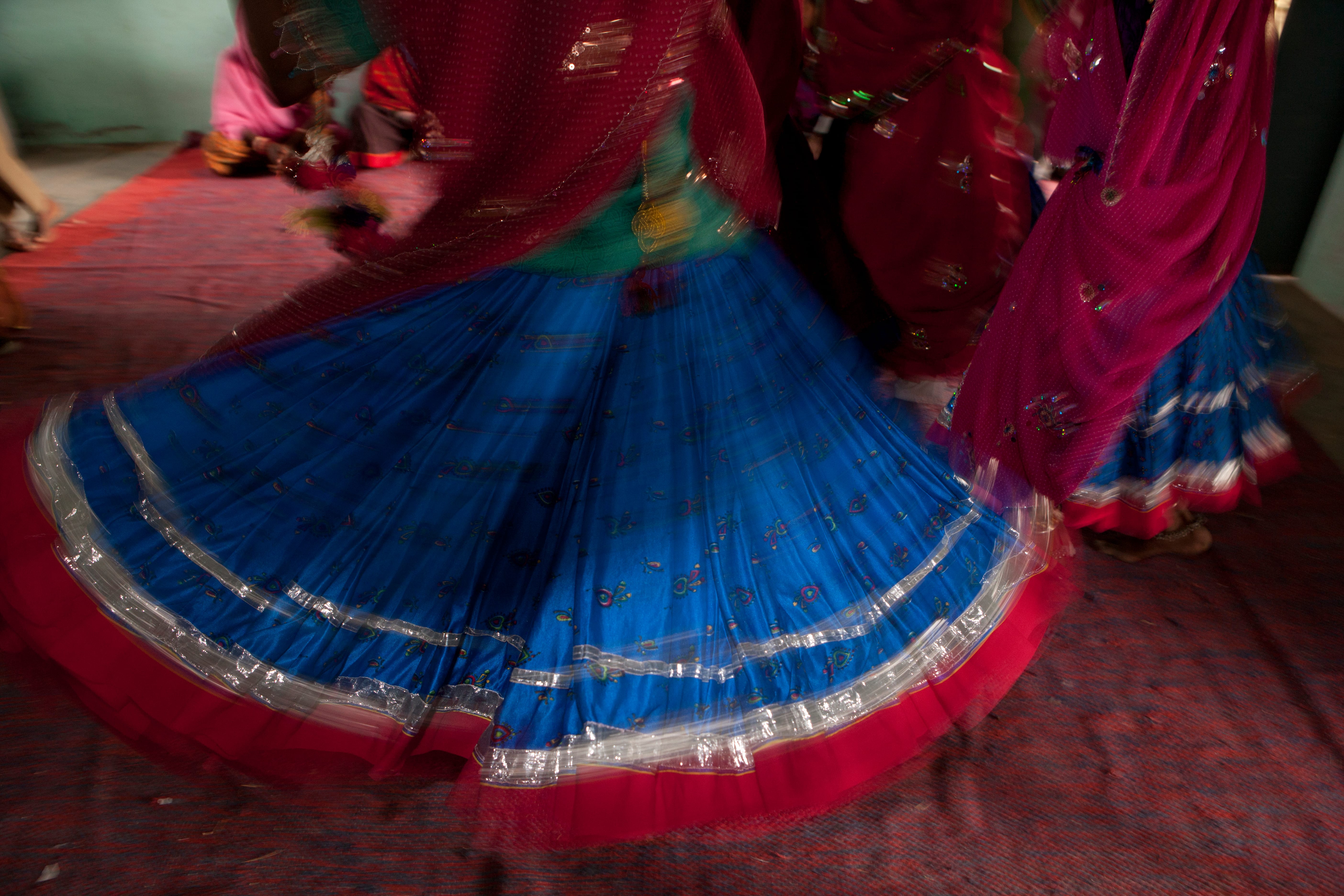 Traditional Rajasthani Skirts swirling at a celebration by Mark Tuschman